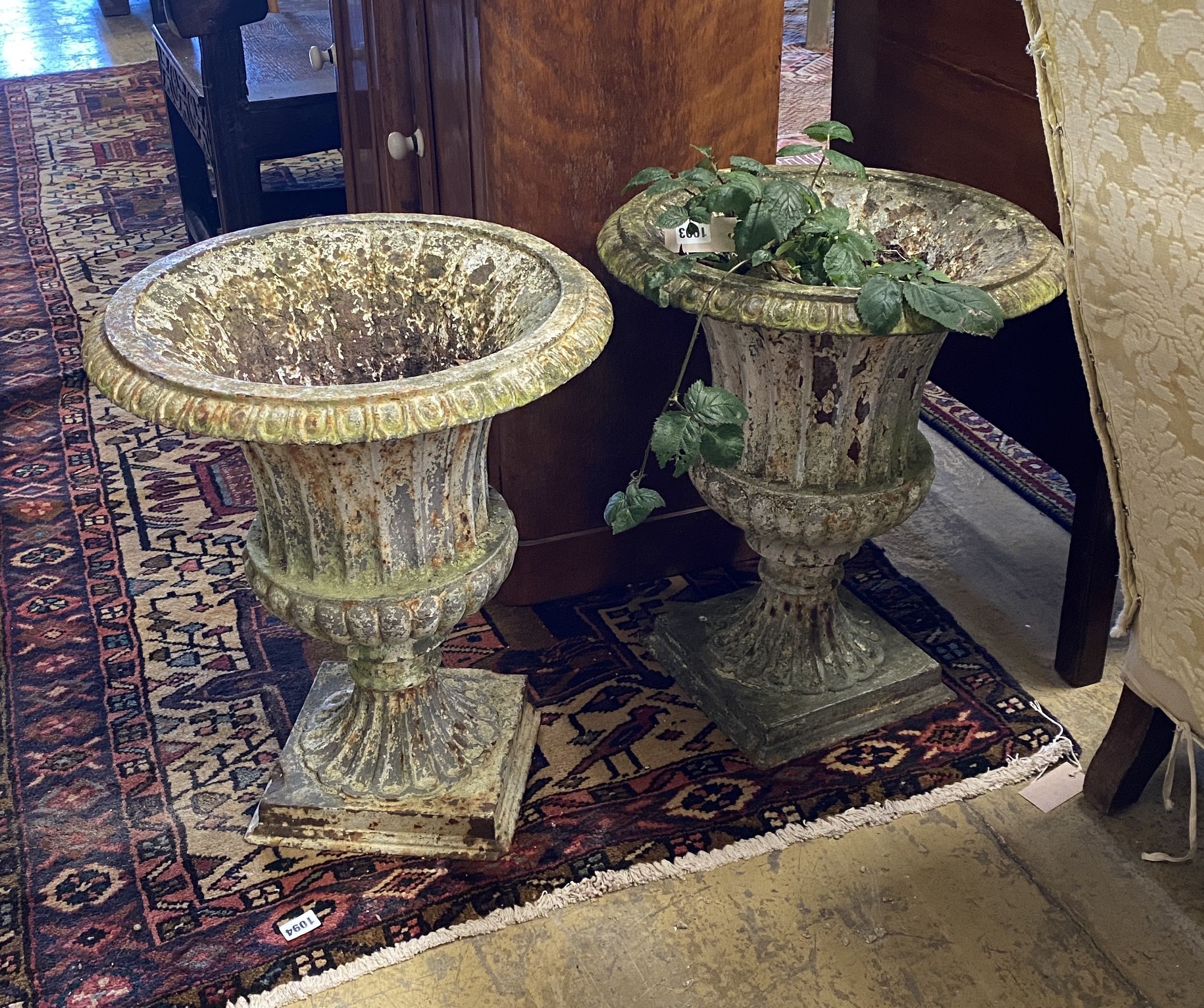 A pair of Victorian painted cast iron campana garden urns, a.f., diameter 44cm, height 50cm